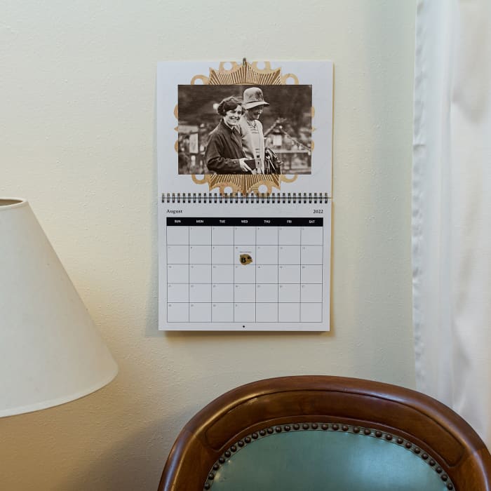 A MyCanvas Custom Wall Calendar hangs in a living room, showing that family photos make great home decor.