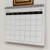 A close-up of a custom Family Photo Wall Calendar shows the crisp high quality printing and black metal wire binding.