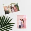 Two 4x6 Classic Prints, one with a white border and one borderless, lay on a white table next to a palm frond.