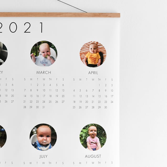 A close up showing the circular baby photos above each month on a 3x4 foot Engineer Print Calendar.