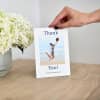 A hand holds a Photo Greeting Card that reads, Thank You! You've got me jumping for joy.