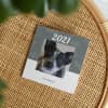 An Instagram Yearbook with a dog on the cover sits on a wicker stool.