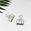 A closeup of a pair of Small silver Skeleton Clips, wire bulldog clips.