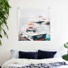A Square Engineer Print featuring a photo of a fishing boat hangs over a bed from a set of Skeleton Clips.