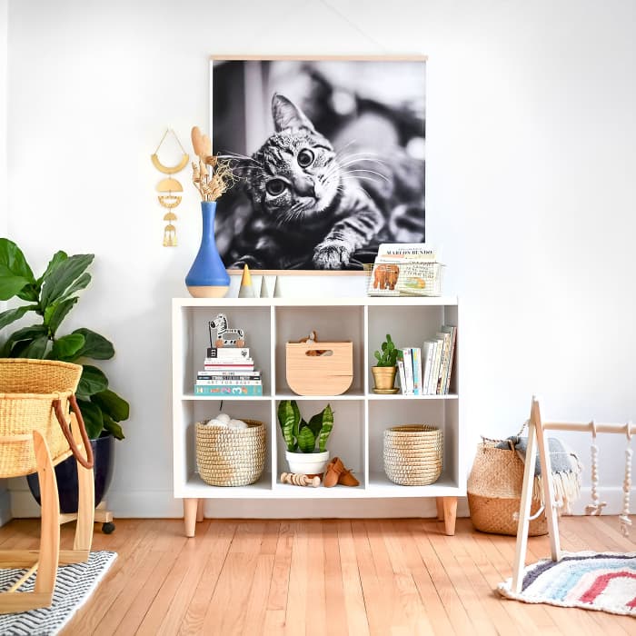 A Square Engineer Print hangs from Maple Poster Rails above a toy shelf as a kids room decor.