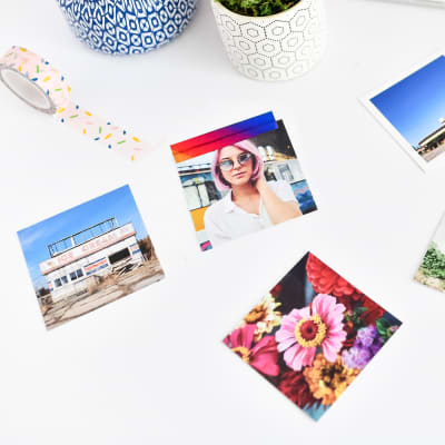 Three 2.75 inch Tiny Square Prints taped to a white desk using rainbow washi tape.