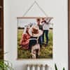 A Fine Art Print showing a sweet family photo hangs from Parabo Press 24 inch Oak Poster Rails.