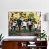 An Engineer Print featuring a family portrait hangs above a credenza from 48 inch Maple Poster Rails.